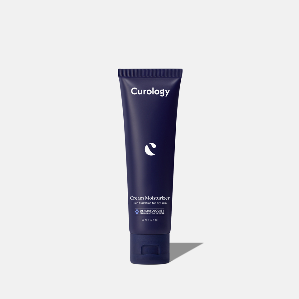 Curology Cream Moisturizer in a dark blue squeeze tube with flip-top cap, labeled ‘Rich hydration for dry skin,’ dermatologist founded, developed, and tested.