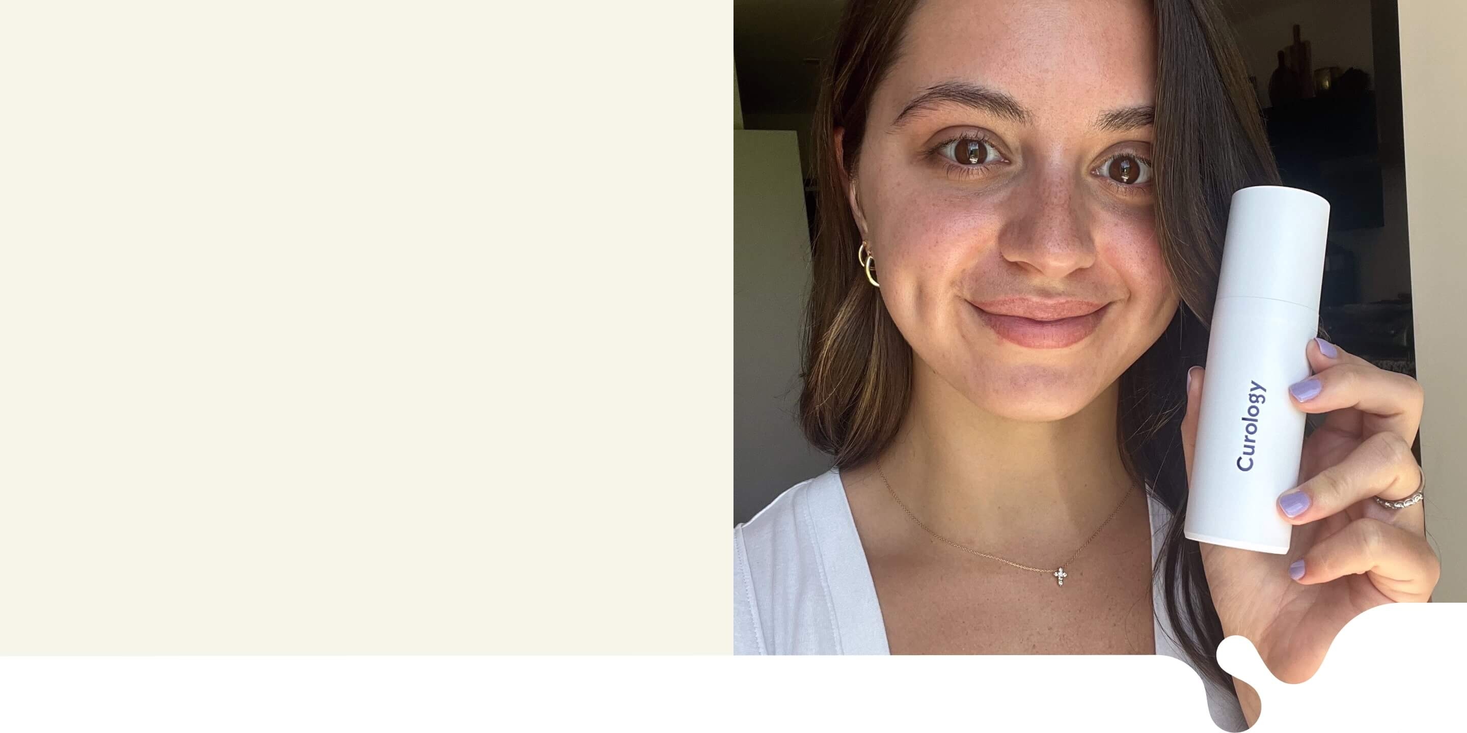 Brunette woman smiling, wearing a white top, holding up a white Custom Formula Curology bottle in her left hand.